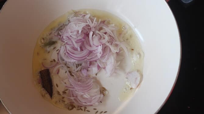 frying onion, spices in oil