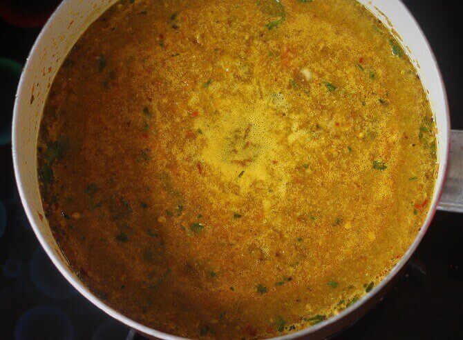 preparing rasam recipe in white pan