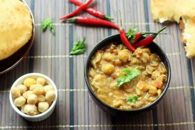 chana masala served in a black bowl garnished with coriander leaves