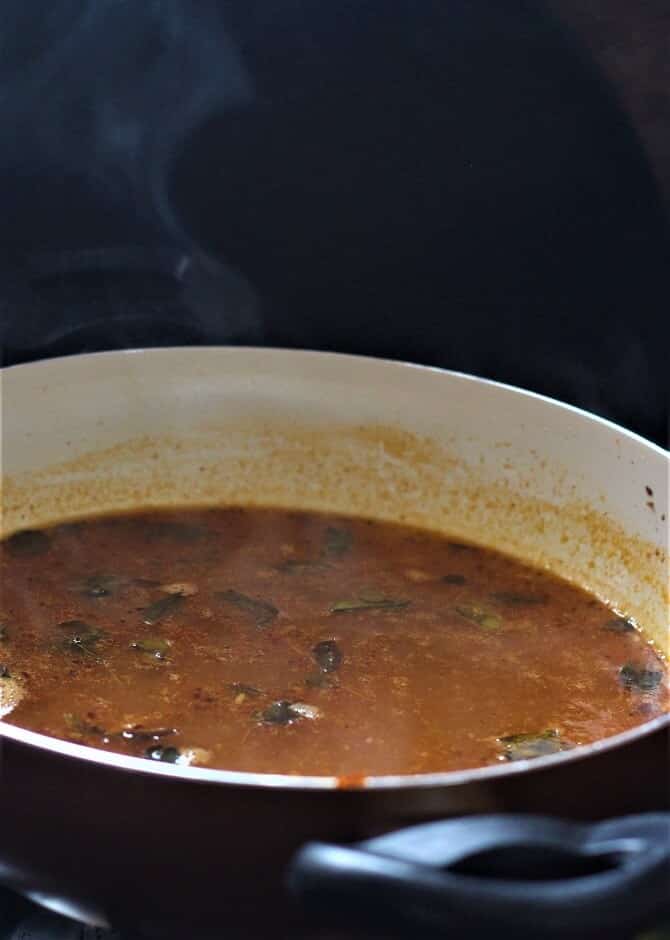 tomato rasam recipe or the thakkali rasam in a white pan
