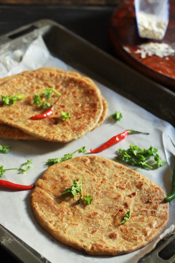 mutton keema paratha garnished with coriander leaves and red chili
