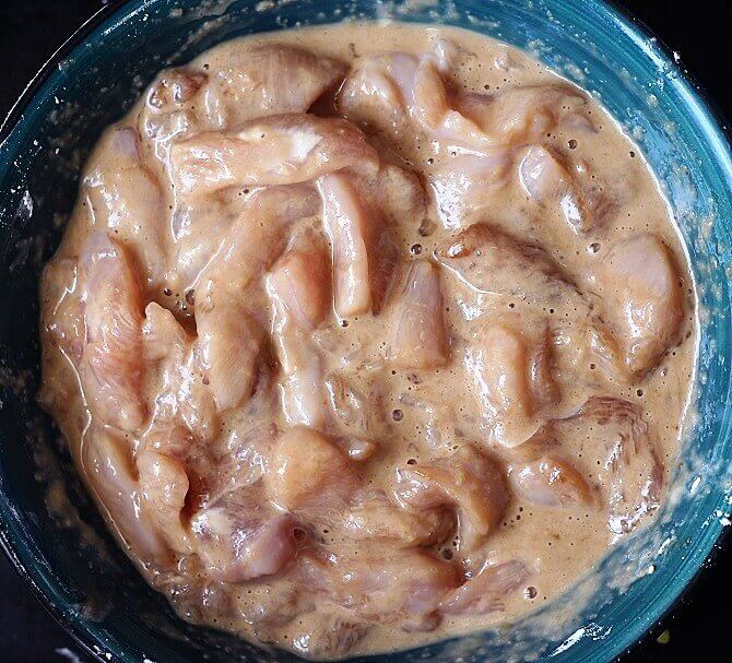 mixing the ingredients with the chicken pieces