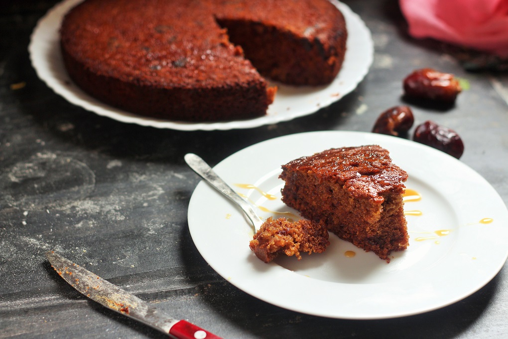 Dates Cake recipe, how to make simple dates cake. Jammed with dates, this cake will be a delight to bake. This recipes calls for boiling the dates before mixing in. And small chunks of cut dates gives that crunchy flavor that will leave you asking for more.