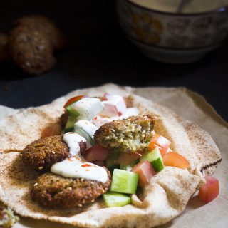 The falafel are one of the favorite Arabic food and a very much integral to the Middle Eastern cuisine. It is eaten as it is, as a snack. Or served in a pita bread along with salad and tahini. For those of you who haven't heard of what a falafel is, it is pretty much similar to the masala vada recipe. Except this easy falafel recipe is made with the chickpeas or the chana.