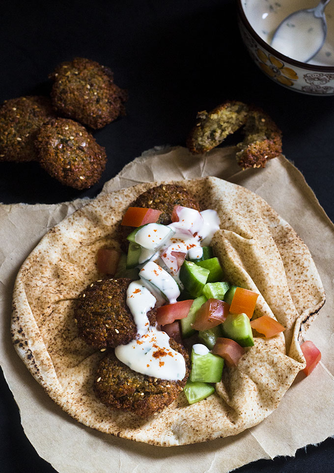 The falafel are one of the favorite Arabic food and a very much integral to the Middle Eastern cuisine. It is eaten as it is, as a snack. Or served in a pita bread along with salad and tahini. For those of you who haven't heard of what a falafel is, it is pretty much similar to the masala vada recipe. Except this easy falafel recipe is made with the chickpeas or the chana.