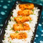 paneer fry placed on cooked rice in a long plate