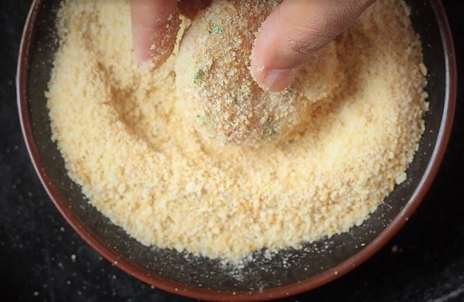 coating tikki with breadcrumbs