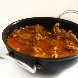 Tamatar Gosht Recipe served in a kadai