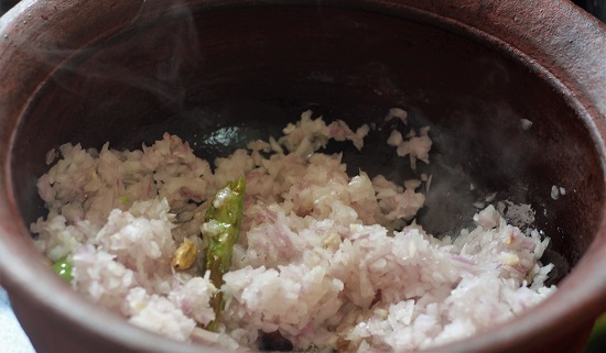 adding chopped onions to the spices in oil