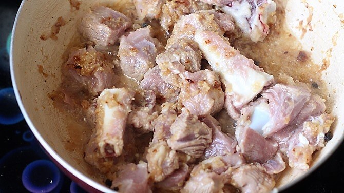 cooking mutton in white pan