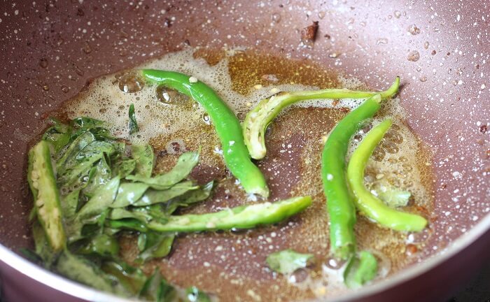 frying green chili, curry leaves in oil