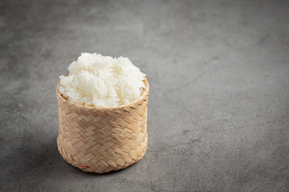 sticky rice in bamboo basket put on dark floor